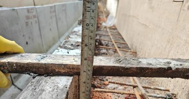 Concrete channel detail with measuring tape.