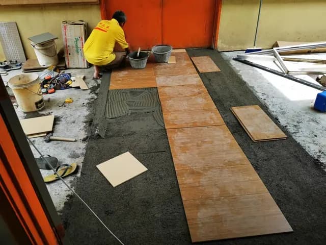 Floor tiling work at the hostel.