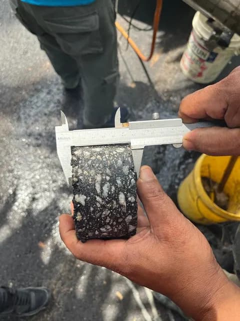 Road-core sample measured with calipers.